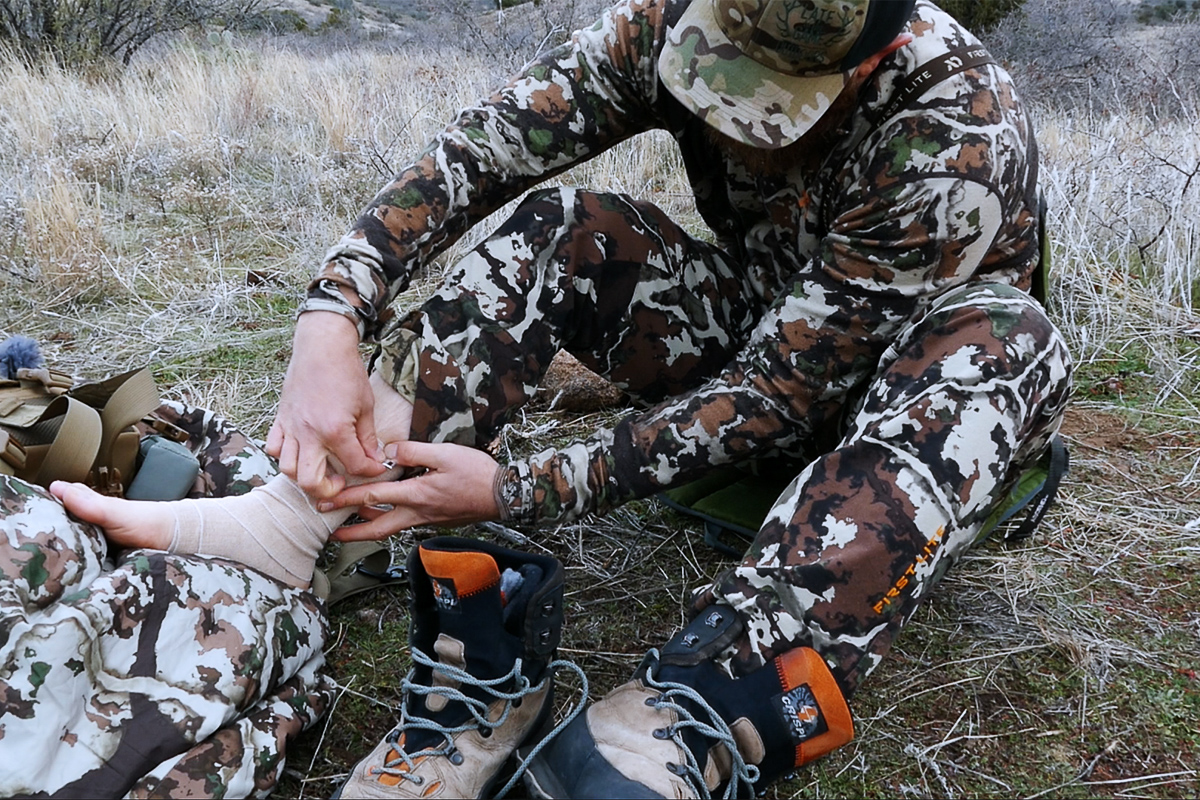 Eric Voris wrapping his ankle with an ace bandage on a solo hunt