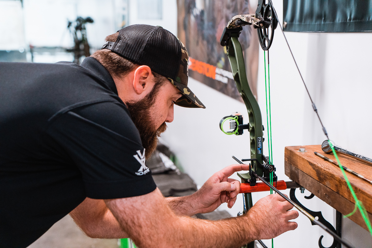 Ross outdoors employee working on tuning a bow
