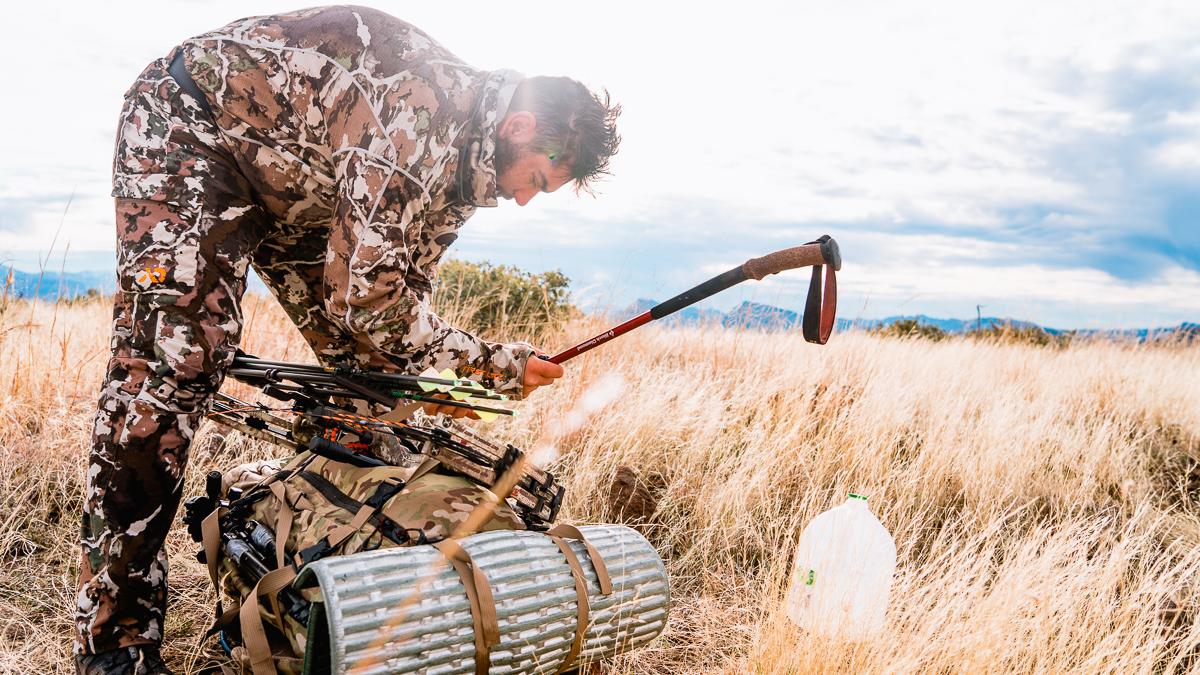 Hunter packing up backpack in the backcountry